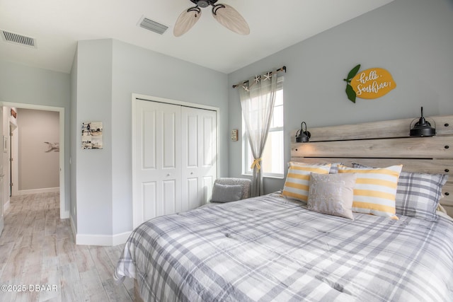 bedroom with ceiling fan, light hardwood / wood-style floors, and a closet