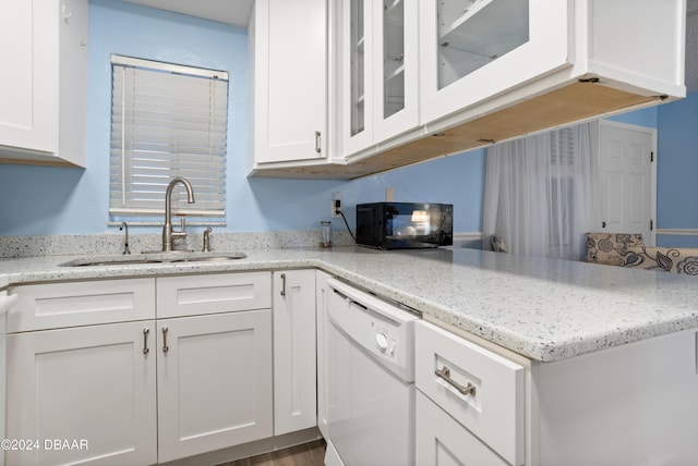 kitchen featuring white cabinetry, dishwasher, and sink