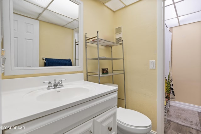 bathroom featuring hardwood / wood-style floors, vanity, and toilet