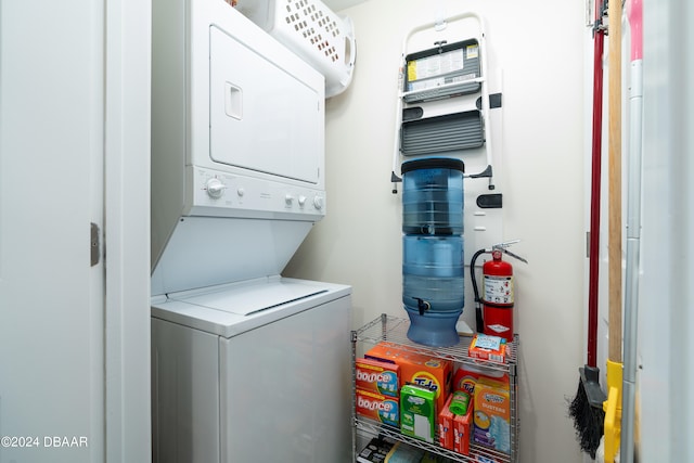 clothes washing area featuring stacked washer / dryer