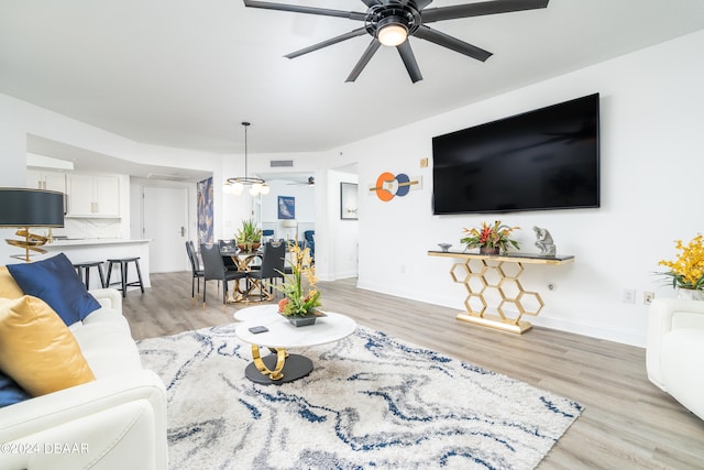 living room featuring light wood-type flooring and ceiling fan