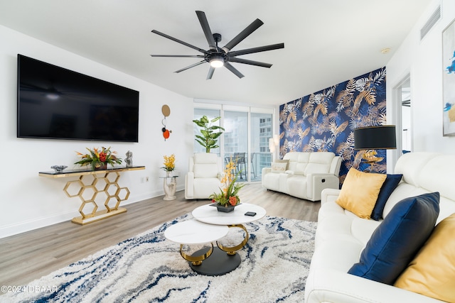 living room featuring hardwood / wood-style flooring, ceiling fan, and floor to ceiling windows