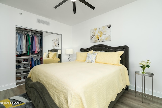 bedroom featuring dark hardwood / wood-style flooring, ceiling fan, and a closet