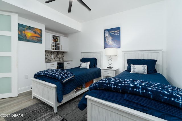 241 Riverside Dr Unit 2007, Holly Hill, FL 32117 - bedroom with wood finished floors, a ceiling fan, a dry bar, and baseboards