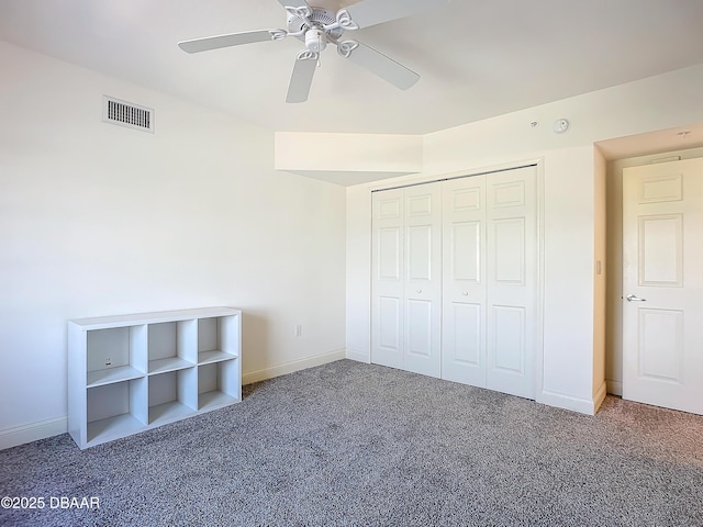 3145 S Atlantic Ave Unit 405, Daytona Beach, FL 32118 - unfurnished bedroom with carpet flooring, baseboards, ceiling fan, and a closet