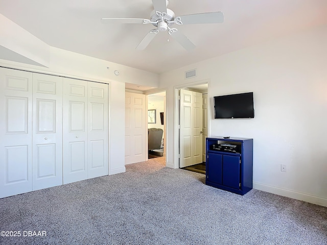 3145 S Atlantic Ave Unit 405, Daytona Beach, FL 32118 - unfurnished bedroom featuring dark carpet, baseboards, a closet, and a ceiling fan
