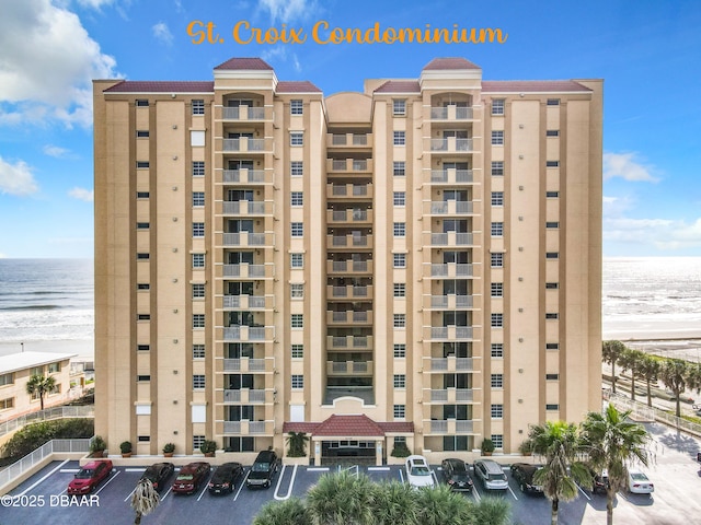 3145 S Atlantic Ave Unit 405, Daytona Beach, FL 32118 - view of apartment building / complex featuring uncovered parking and view of water and beach