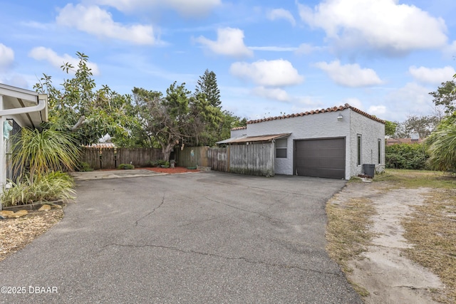 exterior space with fence and aphalt driveway