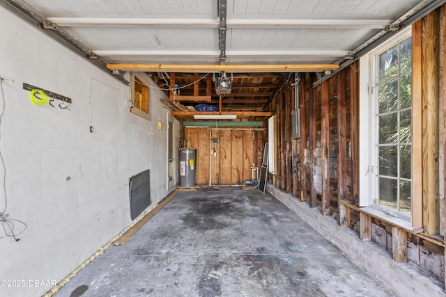 garage featuring a garage door opener and water heater