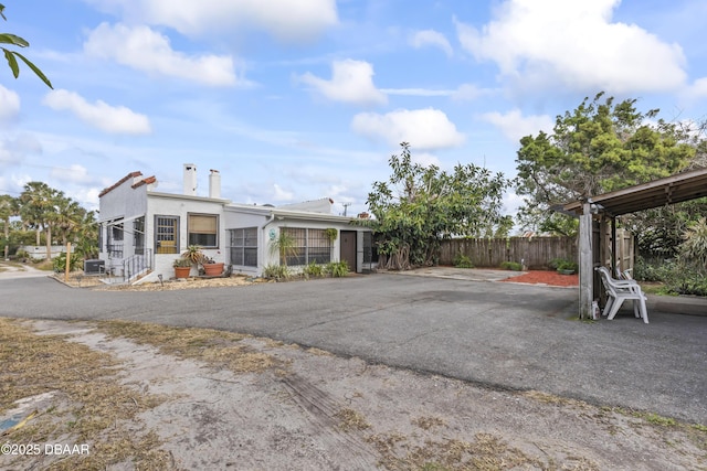 view of front of property featuring fence and stucco siding