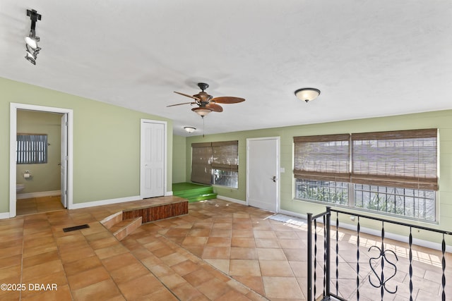 interior space with a ceiling fan and visible vents