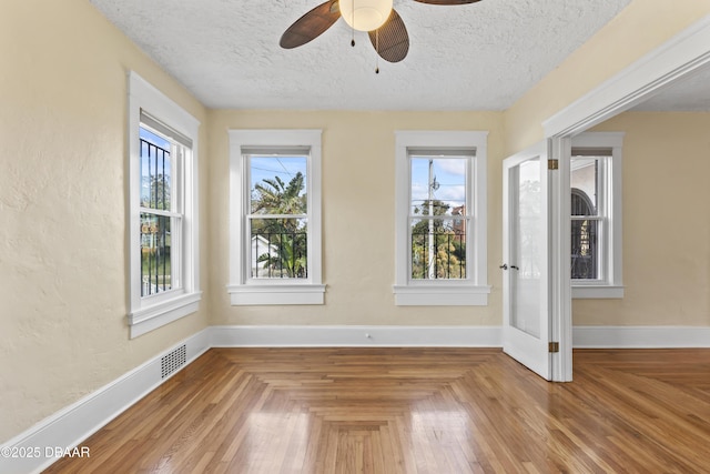 interior space with a textured ceiling, visible vents, and a wealth of natural light