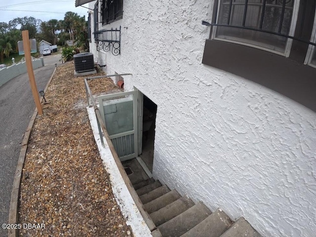 view of storm shelter featuring central air condition unit