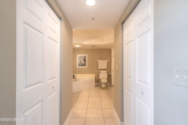 hall with light tile patterned floors