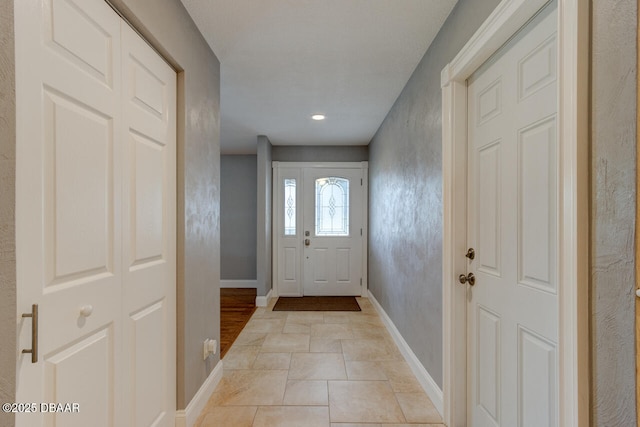 doorway to outside with light tile patterned floors