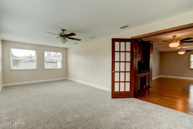 spare room with carpet and ceiling fan