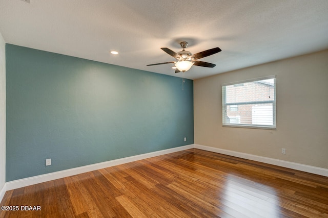 spare room with ceiling fan and hardwood / wood-style floors