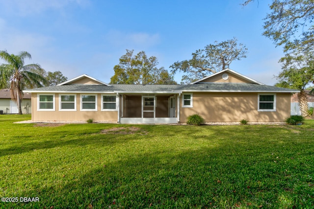 ranch-style house featuring a sunroom and a front lawn