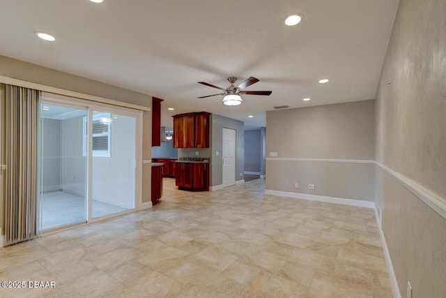 unfurnished living room with ceiling fan