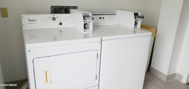 washroom featuring light tile patterned flooring and washer and dryer