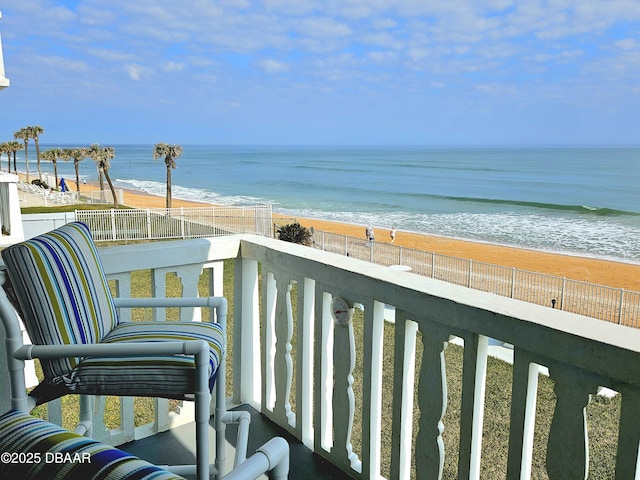 balcony with a beach view and a water view