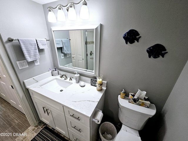 bathroom featuring vanity and toilet