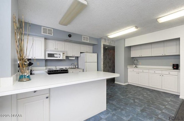 kitchen featuring sink, white cabinetry, a textured ceiling, kitchen peninsula, and white appliances