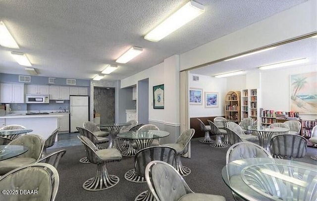 dining room featuring a textured ceiling