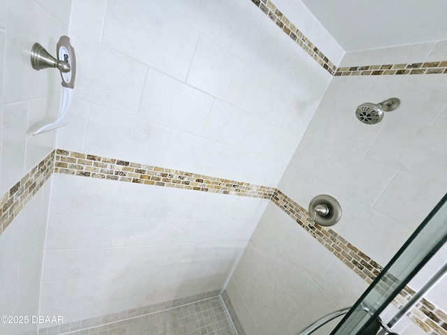 bathroom with tiled shower