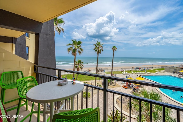 balcony with view of water and beach
