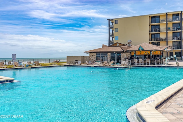 community pool featuring a patio and fence