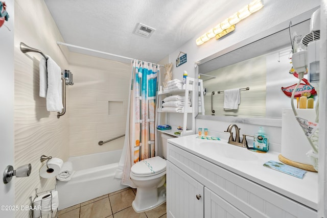 bathroom featuring tile patterned floors, toilet, vanity, shower / tub combo with curtain, and a textured ceiling