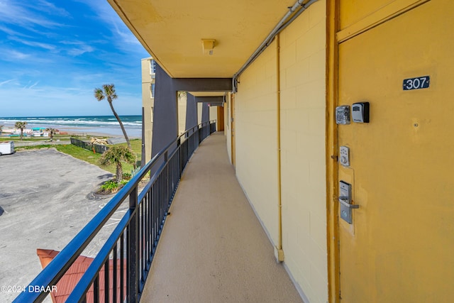 balcony with view of water and beach