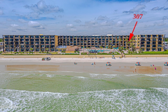 bird's eye view of apartment complex / building and expansive coastline