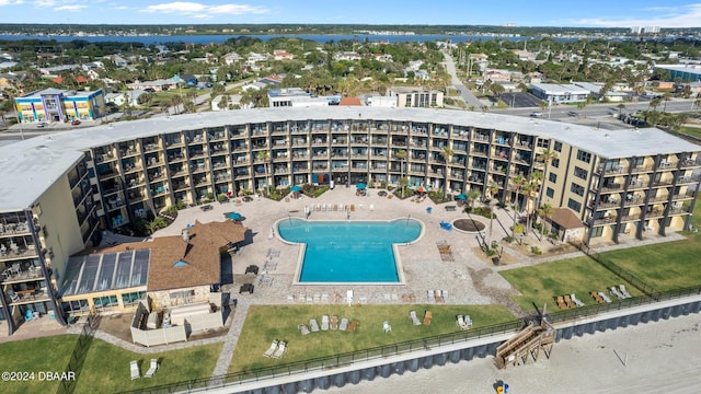 aerial view of property's location with a pool area and apartment complex / building