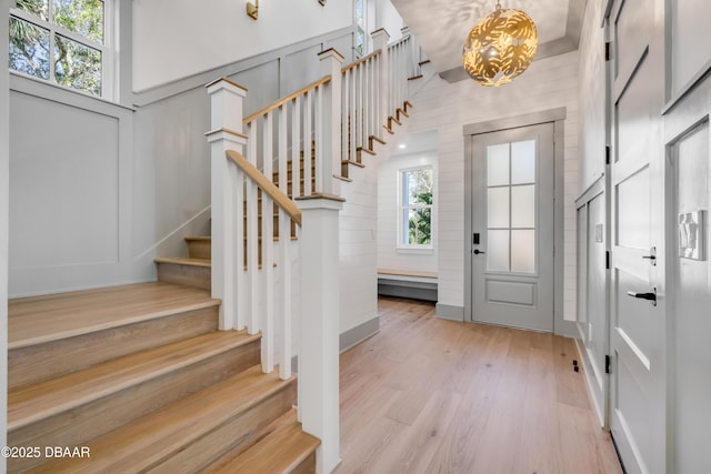 foyer entrance featuring light wood-style floors and stairs