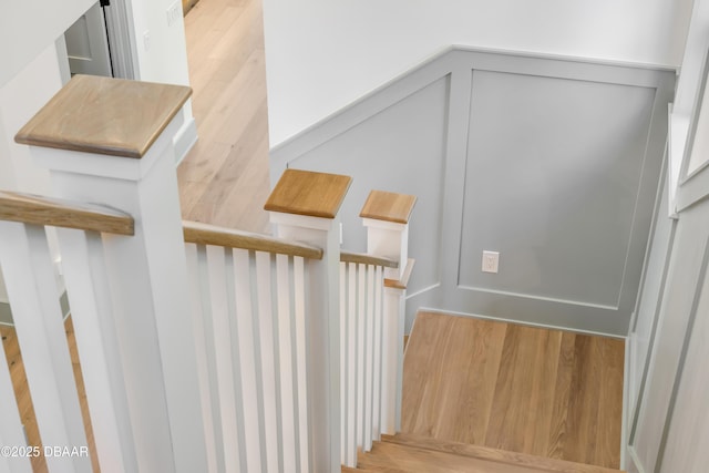 stairs featuring wood finished floors