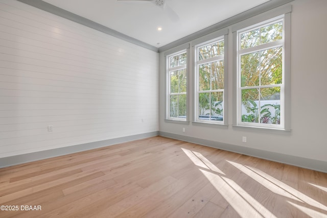 empty room featuring light wood-style flooring and baseboards