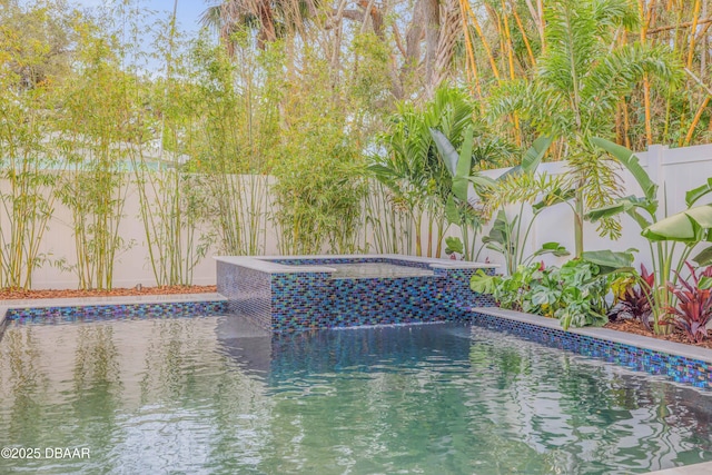 view of pool featuring a fenced backyard, a fenced in pool, and an in ground hot tub