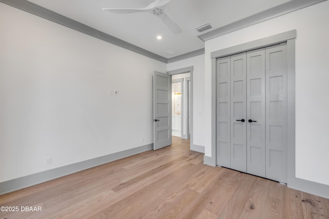 unfurnished bedroom with a closet, visible vents, light wood-style flooring, a ceiling fan, and baseboards