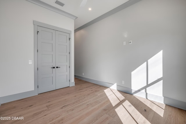 empty room featuring recessed lighting, visible vents, baseboards, and wood finished floors