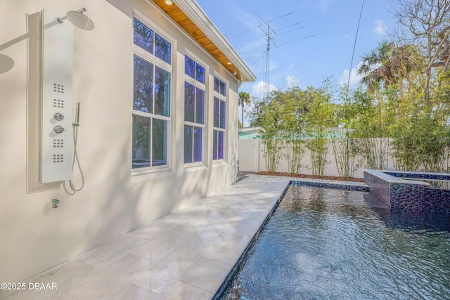 view of property exterior featuring stucco siding, fence, a fenced in pool, and a patio