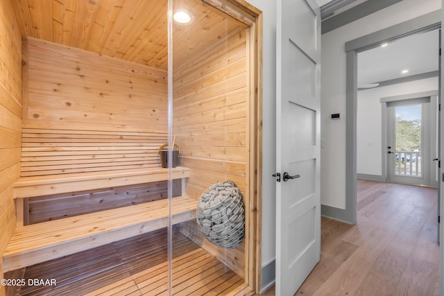 view of sauna / steam room with recessed lighting, baseboards, and wood finished floors