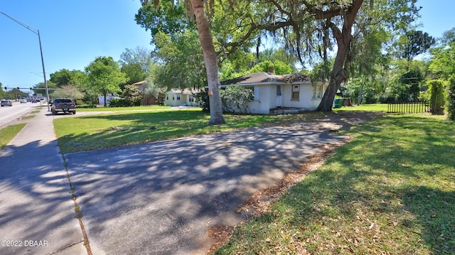 exterior space with a front yard and fence