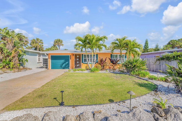 view of front of house featuring driveway, an attached garage, fence, and a front yard