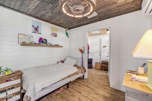 bedroom with light wood-style floors, wood ceiling, visible vents, and a wall mounted AC