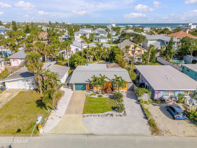 drone / aerial view with a water view and a residential view