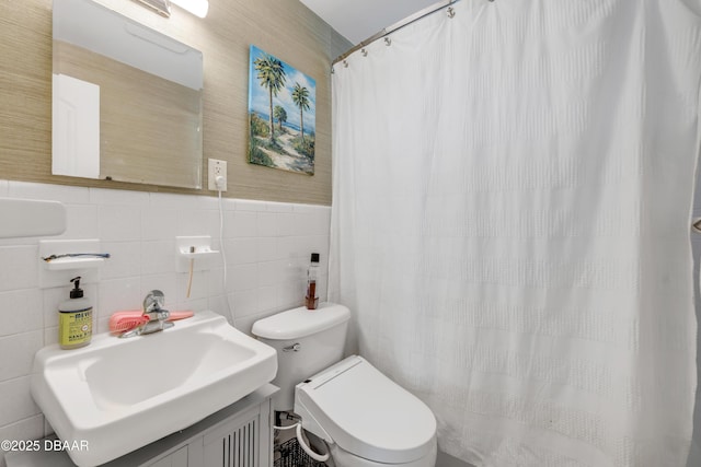 full bathroom with toilet, tile walls, and a sink