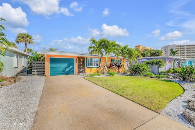 view of front of house featuring a garage, driveway, and a front lawn