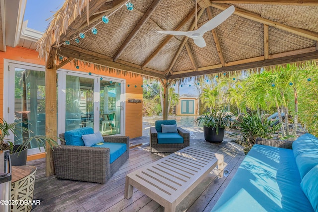 view of patio / terrace with an outdoor hangout area, a gazebo, a wooden deck, and a ceiling fan